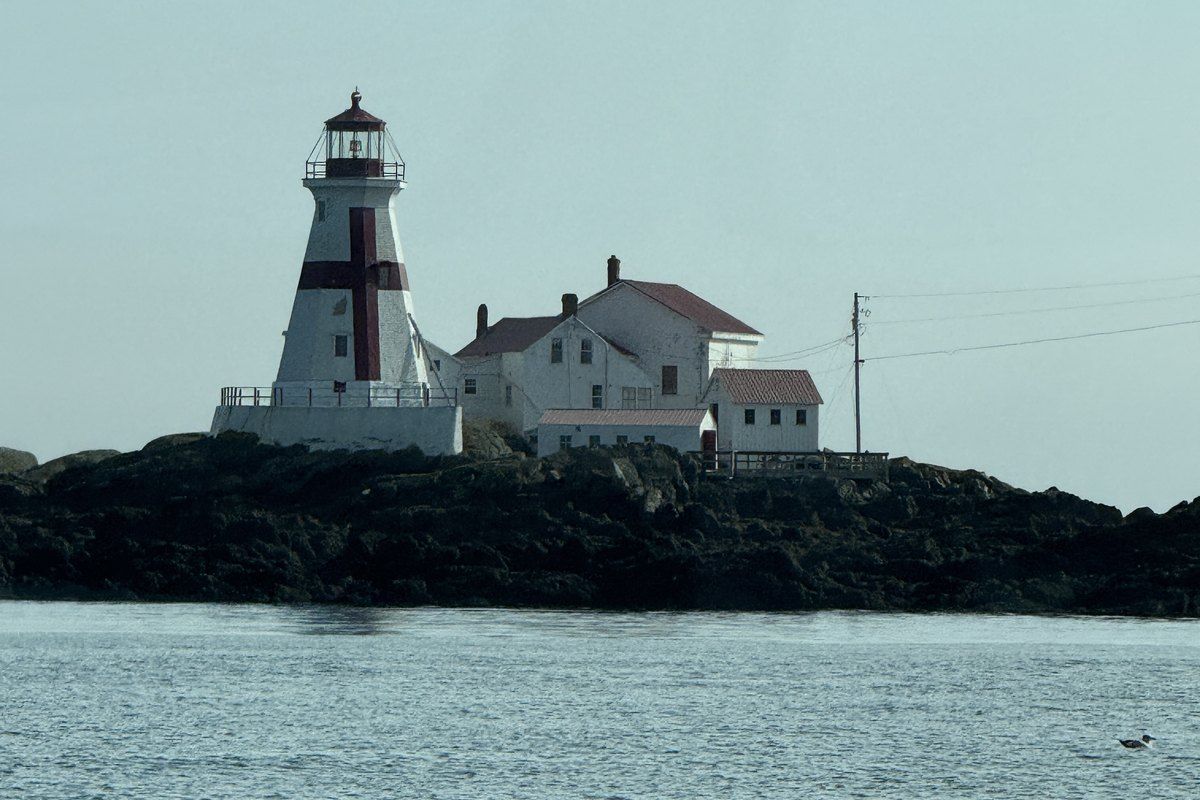 Lighthouse seen through mist and rain during our Bay of Fundy whale-watching excursion