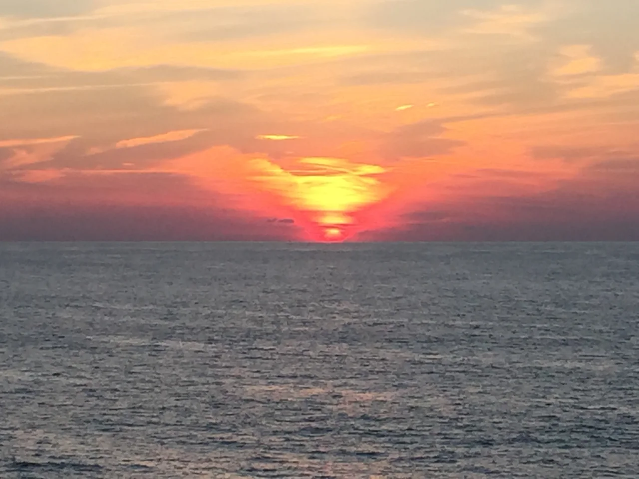 Sunset over open water during the Norwegian Gem cruise